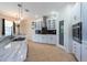 Bright kitchen with white cabinets, black backsplash, tiled island, and stainless steel appliances at 10522 Sky Flower Ct, Land O Lakes, FL 34638