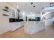 Bright kitchen with white cabinets, black backsplash, tiled island, and stainless steel appliances at 10522 Sky Flower Ct, Land O Lakes, FL 34638