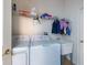 A bright laundry room features a washer, dryer, utility sink and built-in storage at 10522 Sky Flower Ct, Land O Lakes, FL 34638