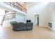Bright living room with tile floors, a spiral staircase, iron railings, and a modern fireplace feature at 10522 Sky Flower Ct, Land O Lakes, FL 34638