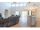 Spacious living room with tile flooring, a stone fireplace, and a view of the outdoor patio at 10522 Sky Flower Ct, Land O Lakes, FL 34638