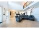Spacious living area with tile flooring, an open layout, spiral staircase, and easy access to the kitchen at 10522 Sky Flower Ct, Land O Lakes, FL 34638