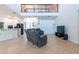 Expansive living room featuring a spiral staircase, tile floors, and an open floor plan into the kitchen at 10522 Sky Flower Ct, Land O Lakes, FL 34638