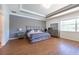 Comfortable main bedroom features recessed ceiling and ample natural light from the large window at 10522 Sky Flower Ct, Land O Lakes, FL 34638