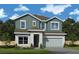 Charming two-story home features a modern design, attached two car garage, and lush landscaping at 10652 Crescent Creek Xing, Parrish, FL 34219
