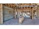 Spacious interior of home ready to be finished with exposed ceiling beams and wooden framing at 10652 Crescent Creek Xing, Parrish, FL 34219