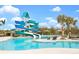 Resort-style pool with winding water slide surrounded by lush tropical landscaping and lounge seating at 10652 Crescent Creek Xing, Parrish, FL 34219