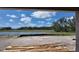 Scenic view from the home of a tranquil lake surrounded by lush trees and clear blue skies at 10652 Crescent Creek Xing, Parrish, FL 34219