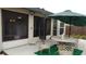 Back patio with outdoor seating and view of manicured backyard, ideal for relaxation at 11217 Fiddlewood Dr, Riverview, FL 33579