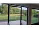 Backyard view from the patio, showcasing serene pond and lush greenery at 11217 Fiddlewood Dr, Riverview, FL 33579