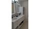 Modern bathroom vanity featuring dual sinks, illuminated mirrors, and stylish decor at 11217 Fiddlewood Dr, Riverview, FL 33579