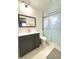 Bathroom featuring a gray vanity, square mirror and a modern glass enclosed shower at 11217 Fiddlewood Dr, Riverview, FL 33579