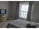 Bright bedroom featuring tile floors, gray walls, and a large window with curtains at 11217 Fiddlewood Dr, Riverview, FL 33579