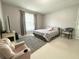 Cozy bedroom with light gray walls, tile floors and a plush armchair at 11217 Fiddlewood Dr, Riverview, FL 33579