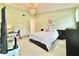 Bright bedroom with high ceilings, a decorative chandelier, and a large bed at 11217 Fiddlewood Dr, Riverview, FL 33579