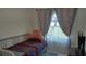 Cozy bedroom with a patterned quilt, plush pillows, and soft lighting at 11217 Fiddlewood Dr, Riverview, FL 33579