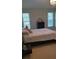 Comfortable bedroom with natural light, a large bed, and ample space at 11217 Fiddlewood Dr, Riverview, FL 33579