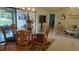 Dining area with glass table, wood chairs, and views of the outdoor lanai at 11217 Fiddlewood Dr, Riverview, FL 33579