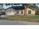 Inviting single-story home featuring an attached garage, well-kept lawn and decorative door at 11217 Fiddlewood Dr, Riverview, FL 33579
