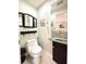 Efficient half-bath features decorative mirror, sink and tile backsplash, and modern fixtures at 11217 Fiddlewood Dr, Riverview, FL 33579