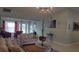 Cozy living room featuring neutral paint, floral sofa and chandelier lighting at 11217 Fiddlewood Dr, Riverview, FL 33579