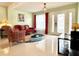 Comfortable living room boasting bright tile floors, an area rug, and direct entry to the home at 11217 Fiddlewood Dr, Riverview, FL 33579