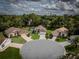 Aerial view of houses situated in a lush, green neighborhood with mature trees at 11368 Copley Ct, Spring Hill, FL 34609