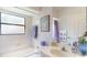 Bathroom with a white tub, vanity, and a mirror at 11368 Copley Ct, Spring Hill, FL 34609