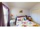 Comfortable bedroom with a floral comforter, side table, and a closet at 11368 Copley Ct, Spring Hill, FL 34609
