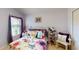 Cozy bedroom with a comfortable bed, floral bedding, and natural light from the window at 11368 Copley Ct, Spring Hill, FL 34609