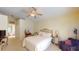 Bright bedroom with a comfortable bed, ceiling fan, and vanity area at 11368 Copley Ct, Spring Hill, FL 34609