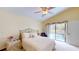 Bright bedroom with a vaulted ceiling, comfortable bed, and access to the pool area at 11368 Copley Ct, Spring Hill, FL 34609