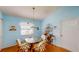 Cozy breakfast nook bathed in bright, light-blue tones, featuring a decorative table and chairs at 11368 Copley Ct, Spring Hill, FL 34609