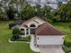 Beautiful home with a well-manicured lawn and a screened-in pool area in the backyard at 11368 Copley Ct, Spring Hill, FL 34609
