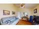 Cozy living room with comfortable seating, ceiling fan, and wood floors at 11368 Copley Ct, Spring Hill, FL 34609