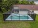 Backyard view of a screened pool, complete with a ladder and steps for easy access at 11368 Copley Ct, Spring Hill, FL 34609