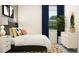 Bedroom with a large window, stylish decor, lamp, and dresser creating a cozy atmosphere at 11809 Sparkling Topaz Cv, Parrish, FL 34219