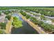 Scenic aerial view highlighting the home's proximity to a tranquil pond, surrounded by lush greenery and well-kept lawns at 13643 Tramore Dr, Odessa, FL 33556