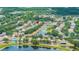 Expansive aerial view captures the home nestled within a community next to a scenic pond at 13643 Tramore Dr, Odessa, FL 33556