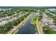 Breathtaking aerial shot showcasing the home situated near a scenic pond surrounded by trees in a vibrant residential area at 13643 Tramore Dr, Odessa, FL 33556
