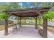 Backyard featuring a covered patio, lake views and lush landscaping, perfect for entertaining at 13643 Tramore Dr, Odessa, FL 33556
