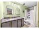 Updated bathroom with granite vanity, stylish lighting, and a shower-tub combo at 13643 Tramore Dr, Odessa, FL 33556
