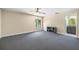 Large bedroom featuring neutral walls, gray carpet and a window allowing natural light at 13643 Tramore Dr, Odessa, FL 33556