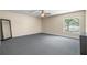 Spacious bedroom featuring neutral walls, gray carpet, and a ceiling fan for added comfort at 13643 Tramore Dr, Odessa, FL 33556