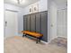 Clean entryway with a coat rack and bench, tile floors and neutral paint at 13643 Tramore Dr, Odessa, FL 33556