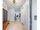Bright entryway featuring tile flooring, coat rack with bench, and an open view into the living spaces at 13643 Tramore Dr, Odessa, FL 33556