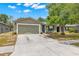 Lovely single-Gathering home featuring a neutral-toned exterior, attached two-car garage, and well-kept landscaping at 13643 Tramore Dr, Odessa, FL 33556