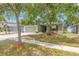 Charming single-story home with well-maintained lawn, mature trees, and a welcoming front entrance at 13643 Tramore Dr, Odessa, FL 33556