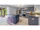 Beautiful kitchen with a center island, stainless steel appliances, granite countertops, and access to outdoor patio at 13643 Tramore Dr, Odessa, FL 33556