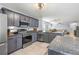 Modern kitchen with granite countertops, stainless steel appliances, gray cabinets, and ample counter space at 13643 Tramore Dr, Odessa, FL 33556